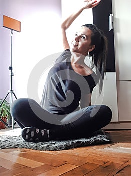 Happy woman stretching  and  doing yoga  at home