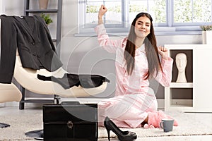 Happy woman stretching in pyjama