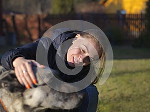 Happy woman stroking dog