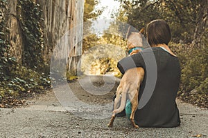 Happy woman stroking her dog