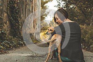 Happy woman stroking her dog