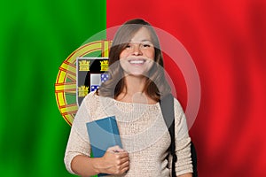 Happy woman student against Portuguese flag background. Travel, education and learn language in Portugal concept