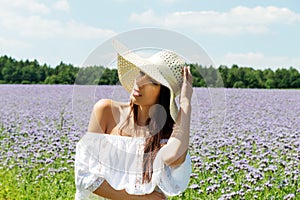 Happy woman in summer field. Young girl relax outdoors. Freedom concept.