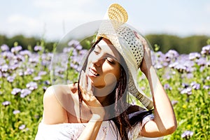 Happy woman in summer field. Young girl relax outdoors. Freedom concept.