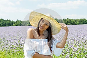 Happy woman in summer field. Young girl relax outdoors. Freedom concept.