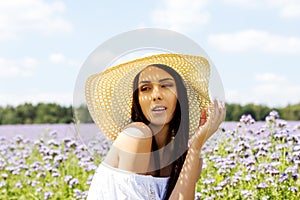 Happy woman in summer field. Young girl relax outdoors. Freedom concept.