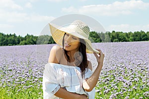 Happy woman in summer field. Young girl relax outdoors. Freedom concept.