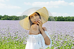 Happy woman in summer field. Young girl relax outdoors. Freedom concept.