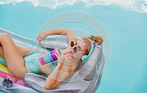 Happy woman summer vacation. Girl in swimmsuit. Summer lady on inflatable mattress.