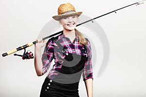 Happy woman in sun hat holding fishing rod