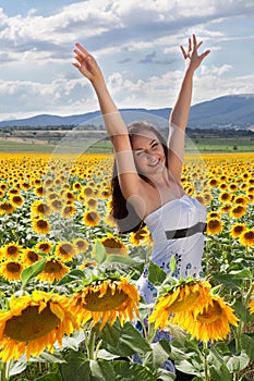 Happy woman in sunflower field