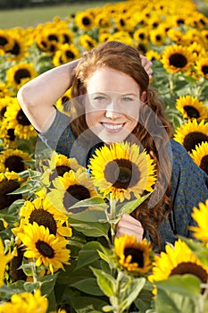Happy Woman in a sunflower field