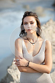 Happy woman at sunset in nature on summer evening