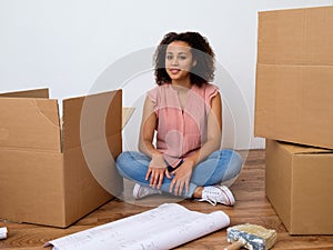 Happy woman surrounded by large boxes