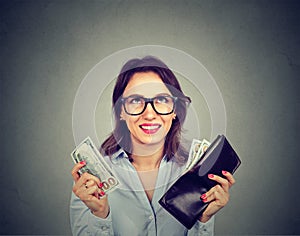 Happy woman taking money out of wallet