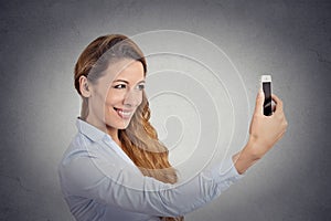 Happy woman taking selfie with smartphone