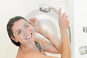 Happy woman taking a shower