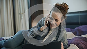 Happy woman talking mobile phone at evening home. Smiling woman call phone