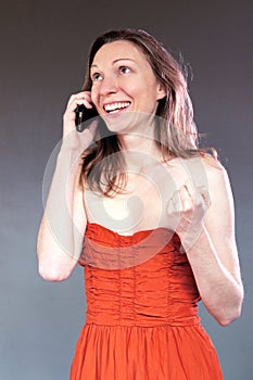 happy woman talking on the mobile phone good news isolated classy young in party dress