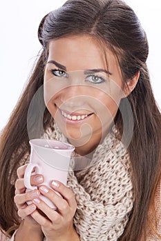 Happy woman with tea mug and pullover,