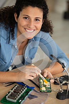 happy woman technician fixing computer