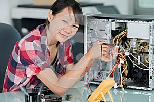 happy woman technician fixing computer