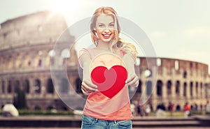 Happy woman or teen girl with red heart shape