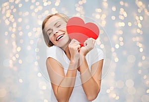 Happy woman or teen girl with red heart shape