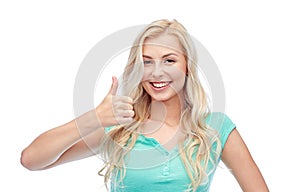 Happy woman or teenage girl showing thumbs up