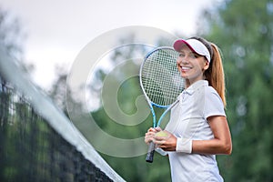 Happy woman with a tennis racket