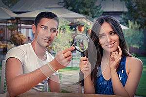 Happy Woman Testing Engagement Ring from Boyfriend with Magnifier