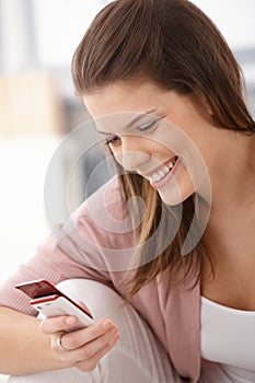 Happy woman texting on mobile phone