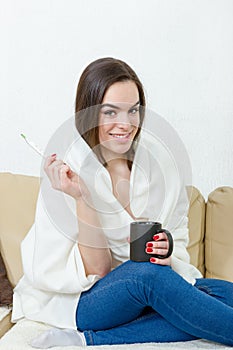Happy woman with thermometer healed of colds