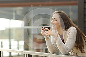 Happy woman thinking at breakfast on vacation