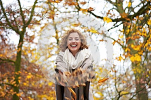 Happy Woman Throwing Leaves