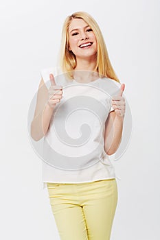 Happy woman, thumbs up or smile in studio portrait with confidence, yes or success by white background. Girl, proud or