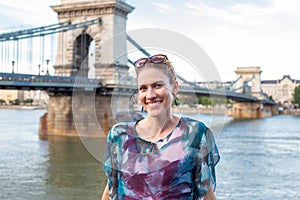 Happy woman with toothy smile at Chain Bridge, Budapest, Hungary