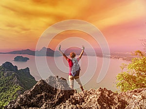 Happy woman on top of a mountain at sunset, Prachuap Khiri Khan, Thailand