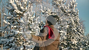 Happy woman tossing snow and turning around having fun at winter forest closeup slow motion