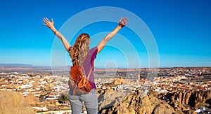 Happy woman tourist with arms outstretched in Spain- Panoramic view of Guadix