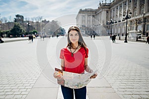 Happy woman tourist in front of Cathedral Santa Maria la Real de La Almudena in Madrid,Spain.Travel addict.