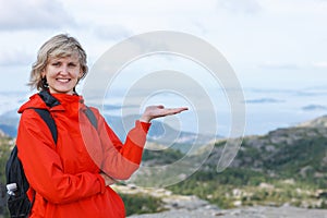 Happy woman tourist showing blank copy space on the palm