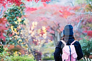 Happy woman tourist traveling in Tenryuji temple at Arashiyama, young Asian traveler visit in Kyoto, Japan. Fall Autumn season,