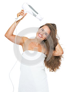 Happy woman in towel blow-dry
