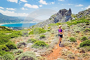 Happy woman trail running in beautiful inspirational landscape