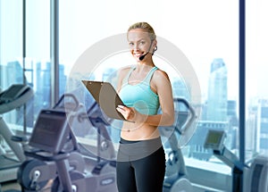 Happy woman trainer with microphone and clipboard