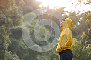 Happy woman traveler breathing fresh air over nature background