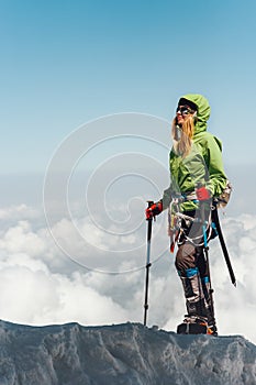 Happy Woman traveler climbing in mountains