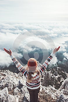 Happy woman traveler on mountain summit