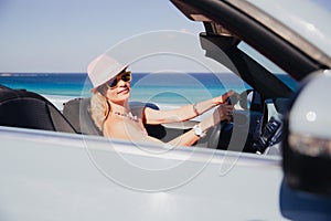 Happy woman travels by car on summer vacation